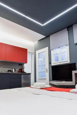 a bedroom with a white bed and red cabinets at CentraL44 YoLo Casual Suite- Ermou in Athens