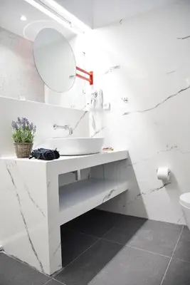 a white bathroom with a sink and a mirror at CentraL44 YoLo Casual Suite- Ermou in Athens