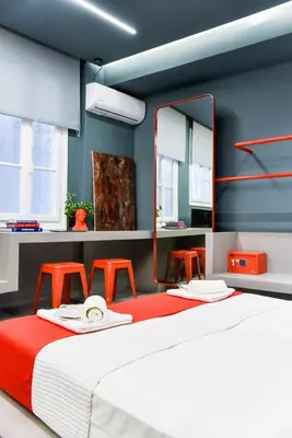 a bedroom with two orange chairs and a mirror at CentraL44 YoLo Casual Suite- Ermou in Athens