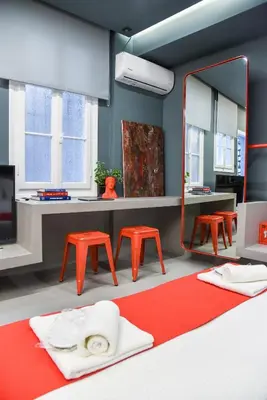 a room with orange chairs and a mirror at CentraL44 YoLo Casual Suite- Ermou in Athens