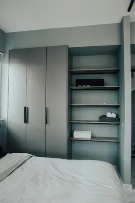 a bedroom with blue walls and a bed at Bango Loft Chalandri, with private parking in Athens