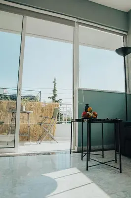 a table with fruit on it in a room with windows at Bango Loft Chalandri, with private parking in Athens