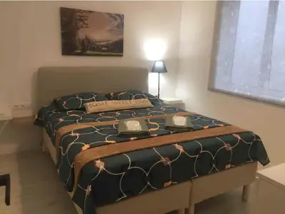 a bedroom with a large bed with a sign on it at Palio Faliro Deluxe Apartment near the sea in Athens