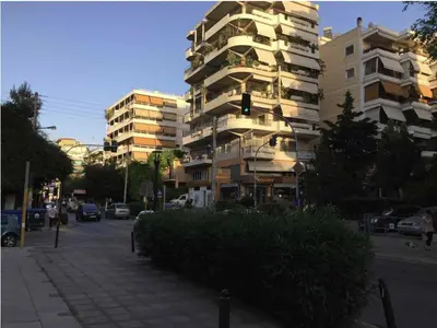 a traffic light in front of a tall building at Palio Faliro Deluxe Apartment near the sea in Athens
