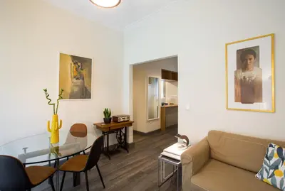 a living room with a couch and a glass table at Acropolis Slow Living apt under the Parthenon in Athens