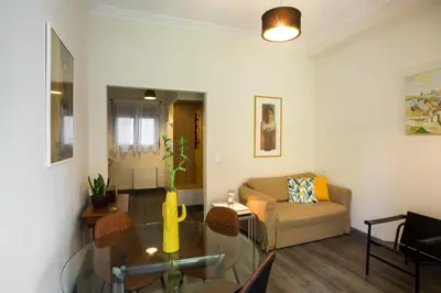 a living room with a glass table and a couch at Acropolis Slow Living apt under the Parthenon in Athens