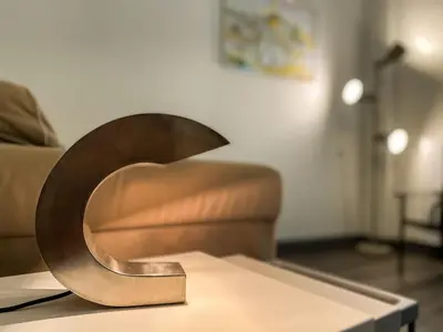 a metal sculpture on a table in a living room at Acropolis Slow Living apt under the Parthenon in Athens