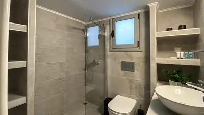 a bathroom with a shower and a toilet and a sink at Acropolis Slow Living apt under the Parthenon in Athens