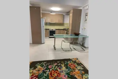 a kitchen with a glass table and a refrigerator at Anna's House in Athens
