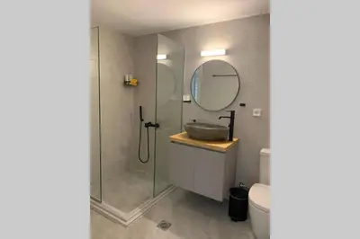 a bathroom with a shower and a sink and a mirror at Anna's House in Athens