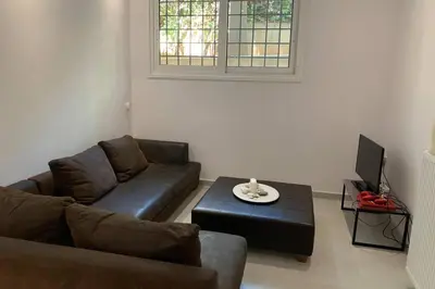 a living room with a couch and a coffee table at Anna's House in Athens