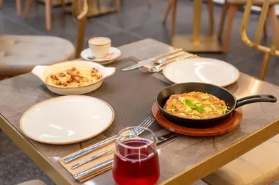 a table with a pan of food and a bowl of food at Hellenic Vibes Smart Hotel in Athens