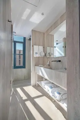 a bathroom with a sink and a mirror at Hellenic Vibes Smart Hotel in Athens