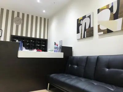 a living room with a black leather couch at Elikon in Athens