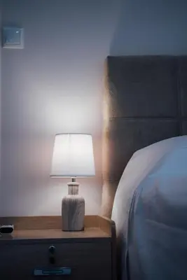 a lamp sitting on a night stand next to a bed at Luxury Apartment in Plaka - Acropolis (Rosemary) in Athens