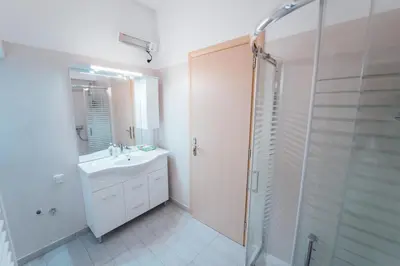 a bathroom with a white sink and a shower at Luxury Apartment in Plaka - Acropolis (Rosemary) in Athens