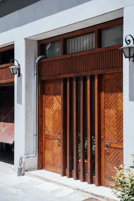 a pair of wooden doors on a building at Luxury Apartment in Plaka - Acropolis (Rosemary) in Athens