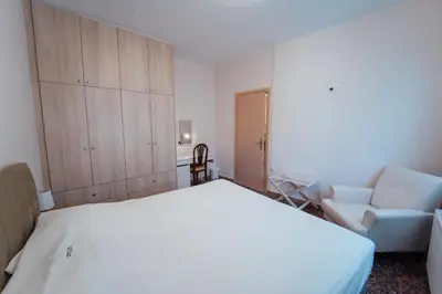 a bedroom with a large white bed and a chair at Luxury Apartment in Plaka - Acropolis (Lavender) in Athens
