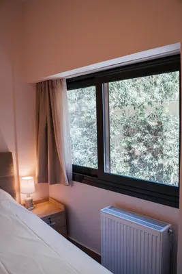 a bedroom with a bed and a large window at Luxury Apartment in Plaka - Acropolis (Lavender) in Athens