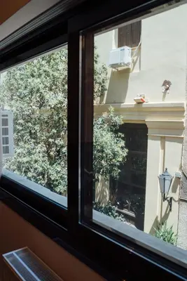 a window with a view of a plant at Luxury Apartment in Plaka - Acropolis (Lavender) in Athens