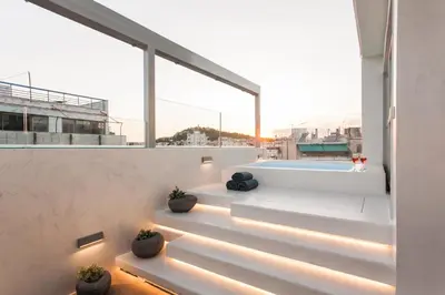 a view from the balcony of a house with a swimming pool at ACRON suites & apartments in Athens