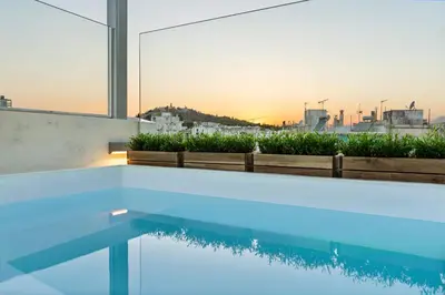 a swimming pool with a view of the city at ACRON suites & apartments in Athens