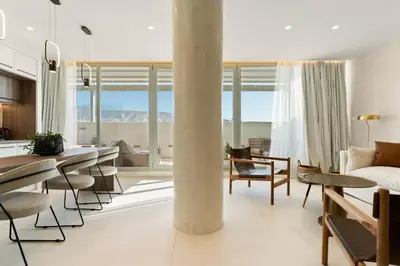 a living room with a table and chairs and a couch at ACRON suites & apartments in Athens
