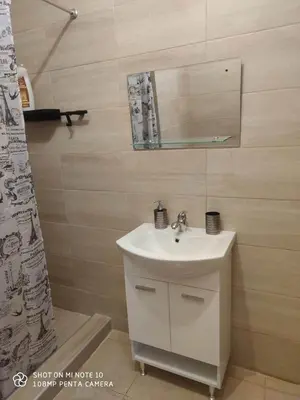 a bathroom with a sink and a mirror at Apartment Maxim in Athens