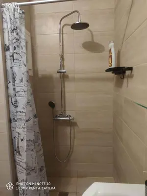 a shower in a bathroom with a shower curtain at Apartment Maxim in Athens
