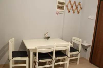 a white table and chairs in a room at Apartment Maxim in Athens