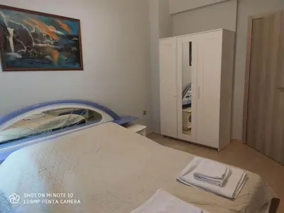 a bedroom with a bed and a painting on the wall at Apartment Maxim in Athens