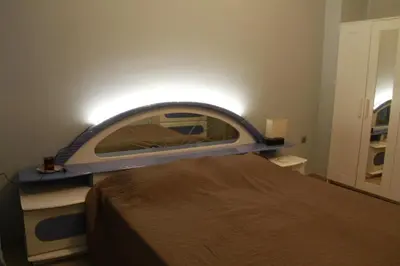 a bedroom with a bed with a large mirror at Apartment Maxim in Athens