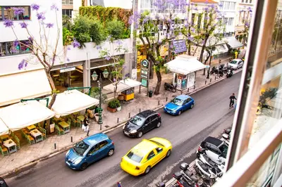 a group of cars parked on a city street at Eunoia Suite - Monastiraki Square View in Athens