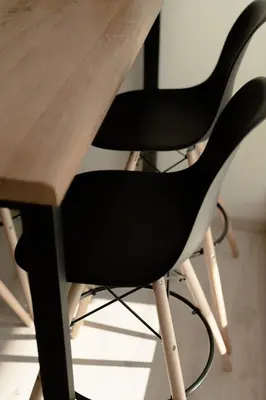 a black and white chair next to a wooden table at Eunoia Suite - Monastiraki Square View in Athens