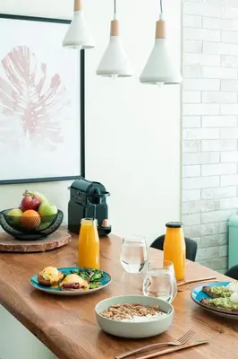 a table with plates of food and glasses of orange juice at Eunoia Suite - Monastiraki Square View in Athens