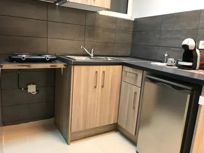 a small kitchen with a sink and a dishwasher at Athens Spirit 49 katechaki apartment in Athens