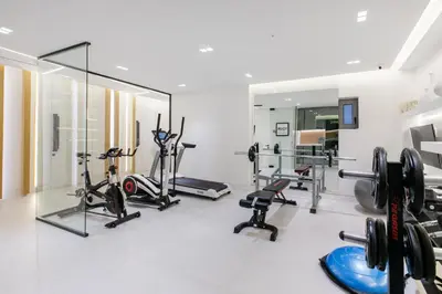 a gym with several treadmills and exercise bikes at NS PLACE Modern Apartment Acropolis view in Athens