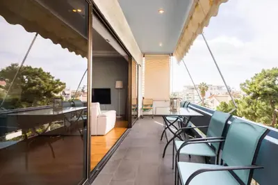 a balcony with a dining table and chairs at Βright Walled Designed Apt in Glyfada Center 1Gbps in Athens
