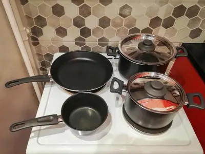two pots and pans sitting on a stove at Stylish Modern Studio in the Heart of Athens in Athens