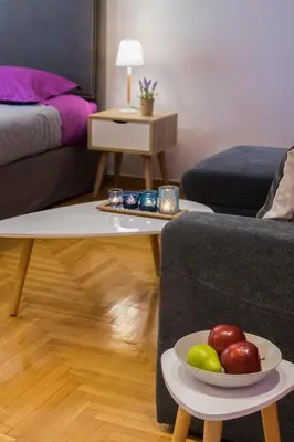 a living room with a plate of fruit on a table at Stylish Modern Studio in the Heart of Athens in Athens