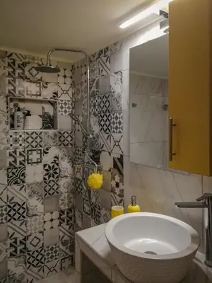 a bathroom with a white sink and a shower at Stylish Modern Studio in the Heart of Athens in Athens