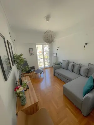 a living room with a couch and a table at Acropolis Exceptional View II in Athens