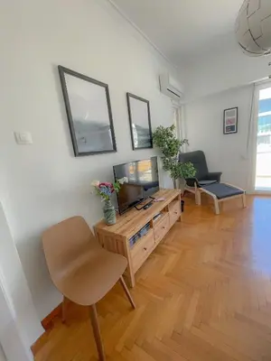 a living room with a television and a table at Acropolis Exceptional View II in Athens