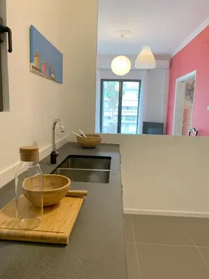 a kitchen with a sink and a bowl on a cutting board at New Modern Apartment - Athens Seaside - 3 Bedrooms in Athens