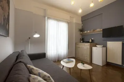 a living room with a couch and a kitchen at Apollonos Amalia one bedroom in Athens