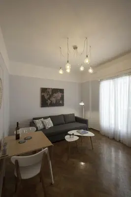 a living room with a couch and a table at Apollonos Amalia one bedroom in Athens