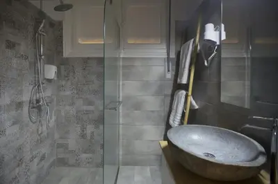 a bathroom with a sink and a glass shower at Apollonos Amalia one bedroom in Athens