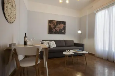 a living room with a couch and a table at Apollonos Amalia one bedroom in Athens