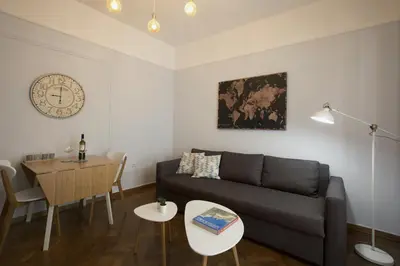 a living room with a couch and a table at Apollonos Amalia one bedroom in Athens