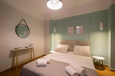 a bedroom with a large bed with towels on it at Apollonos Studio Amalia in Athens